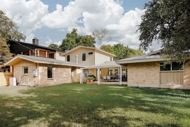 back of property with central AC, a yard, and a patio