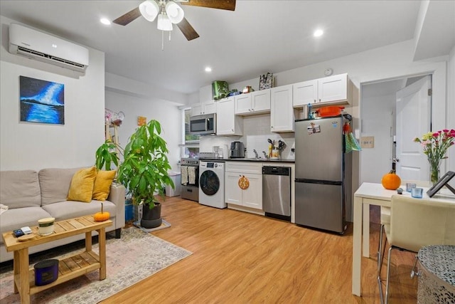 306 E 30th St Unit 102, Austin, TX 78705 - kitchen featuring appliances with stainless steel finishes, an AC wall unit, washer / clothes dryer, a ceiling fan, and backsplash