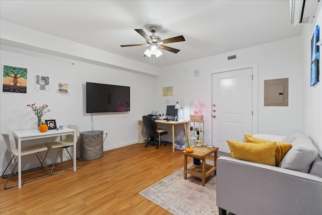 living room featuring hardwood / wood-style flooring, ceiling fan, and electric panel