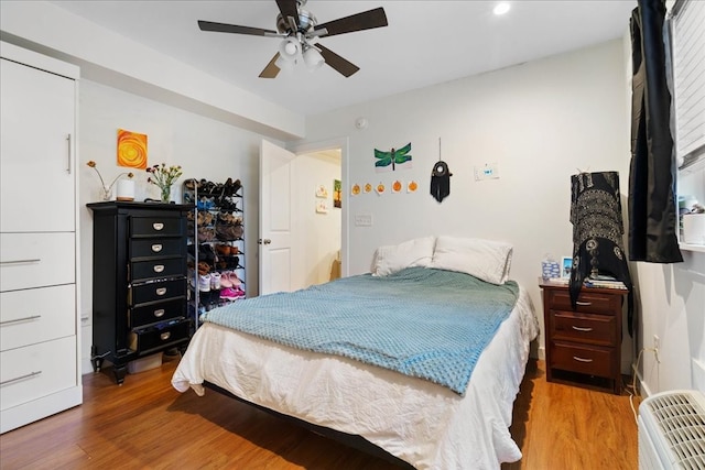 bedroom featuring hardwood / wood-style floors and ceiling fan