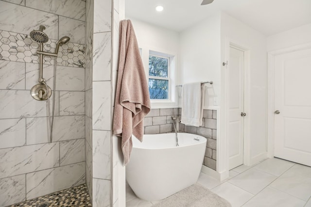 bathroom with tile patterned floors, separate shower and tub, and tile walls