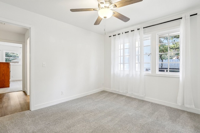 unfurnished room featuring light carpet and ceiling fan