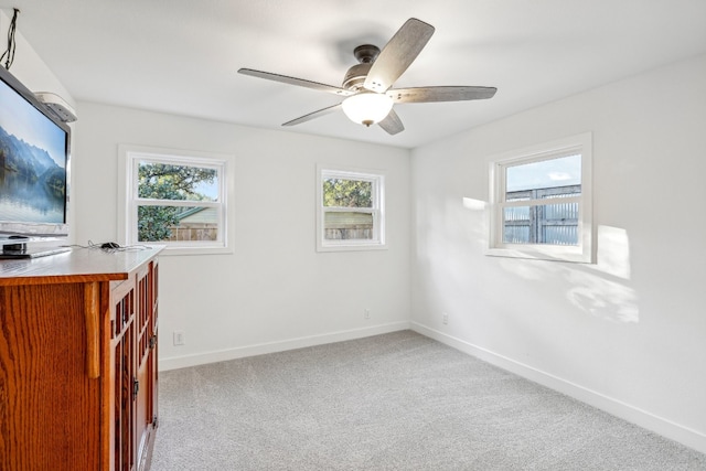 spare room featuring light carpet and ceiling fan