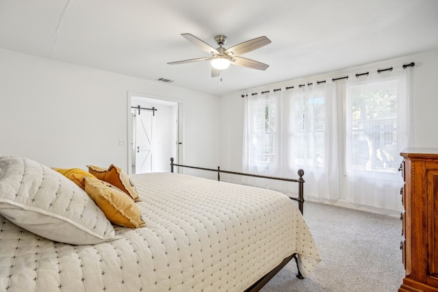 bedroom featuring light colored carpet and ceiling fan