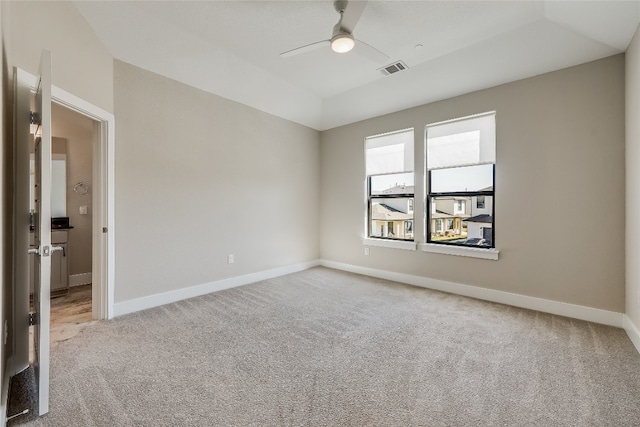 carpeted spare room featuring ceiling fan