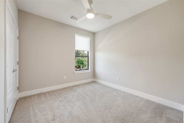 carpeted spare room with ceiling fan