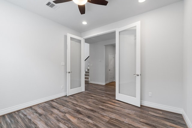 unfurnished room featuring dark wood-type flooring, ceiling fan, and french doors