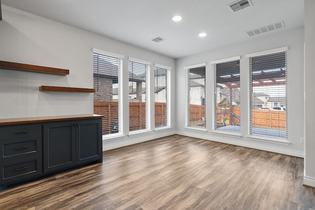 unfurnished dining area featuring hardwood / wood-style flooring