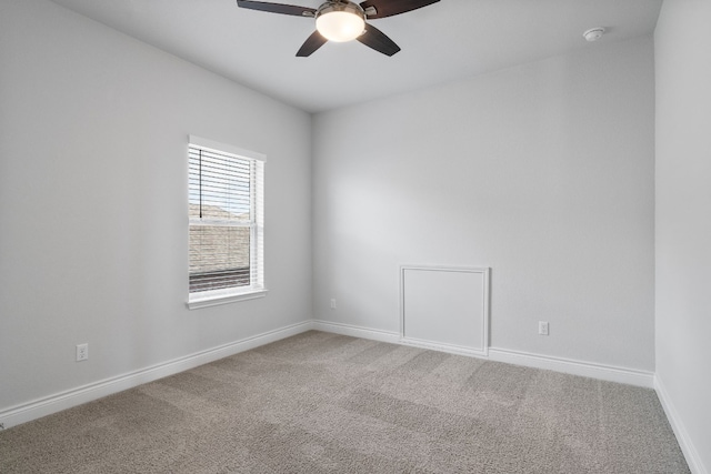 spare room featuring ceiling fan and carpet