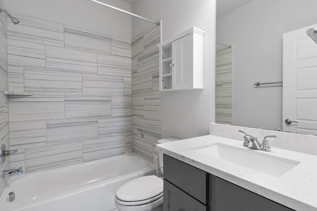 full bathroom with vanity, toilet, and tiled shower / bath combo