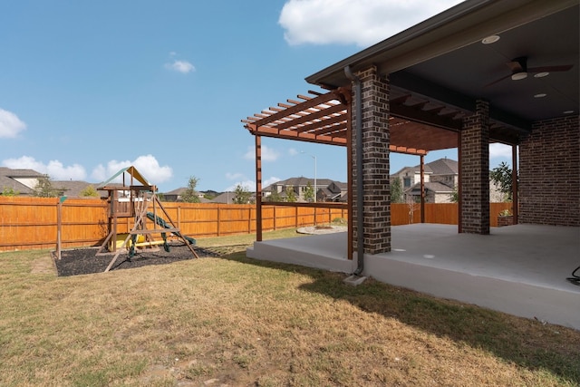 view of yard with a playground, a patio, and ceiling fan