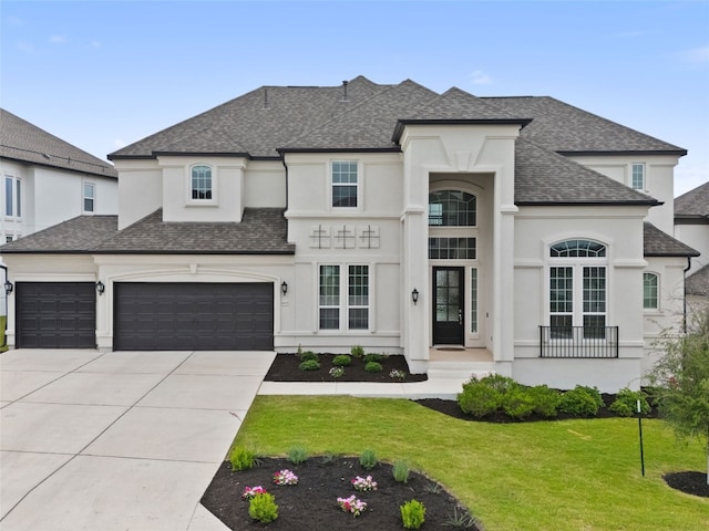 french provincial home with a garage and a front yard