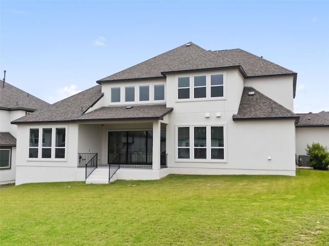 back of house with a lawn and central AC