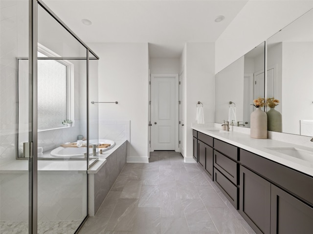 bathroom with vanity and shower with separate bathtub