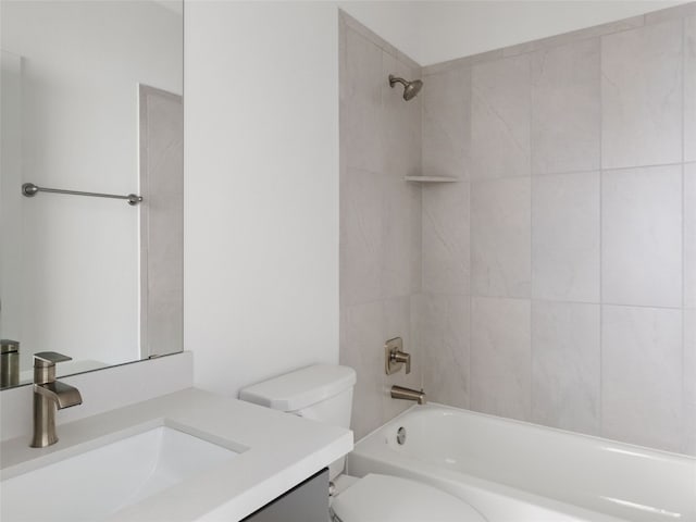 full bathroom featuring vanity, toilet, and tiled shower / bath combo