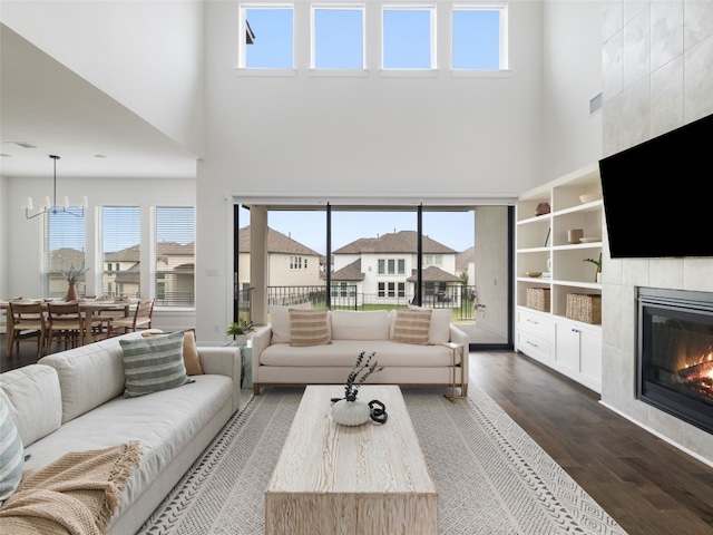 living room featuring a towering ceiling and a healthy amount of sunlight