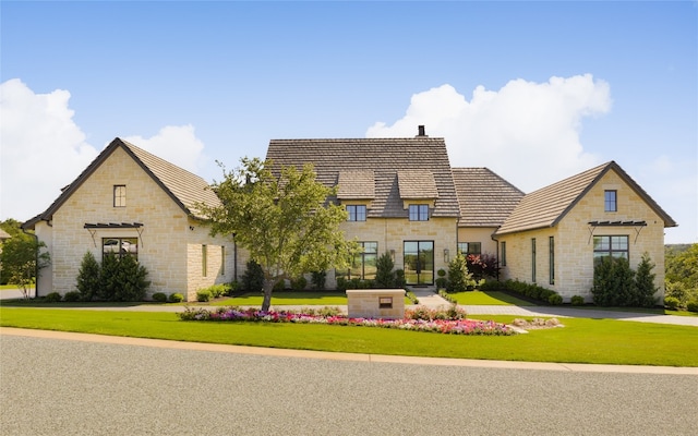 french country home featuring a front lawn