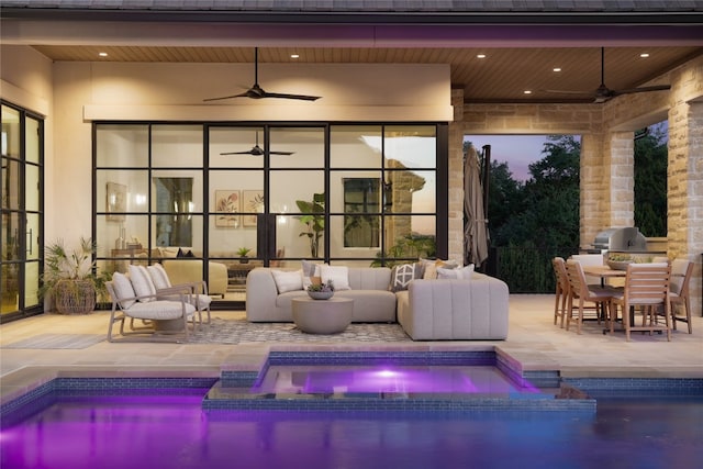 view of pool featuring outdoor lounge area, grilling area, ceiling fan, an in ground hot tub, and a patio area