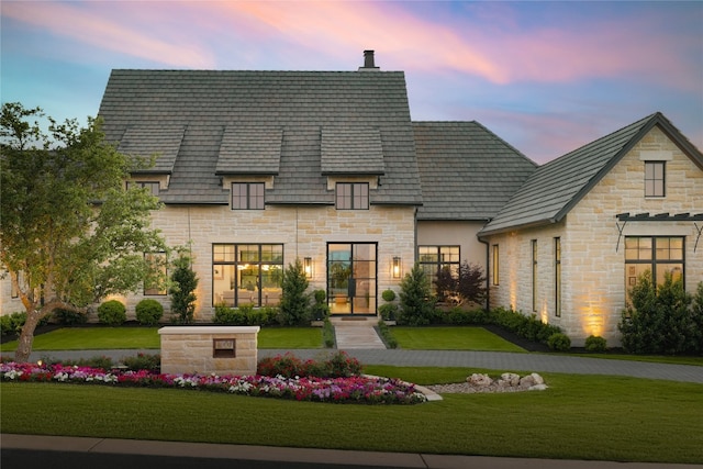 view of front of home with a lawn