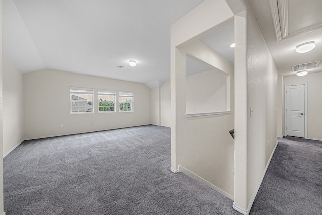 additional living space featuring lofted ceiling and carpet flooring