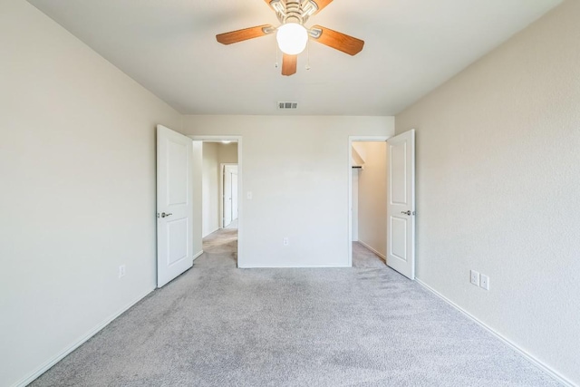 unfurnished bedroom featuring light carpet and ceiling fan