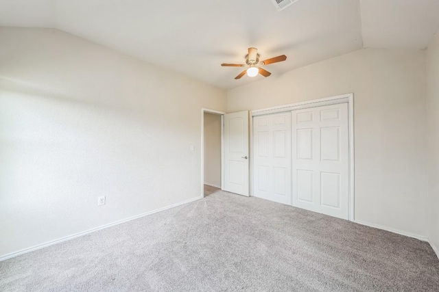 unfurnished bedroom featuring vaulted ceiling, ceiling fan, carpet floors, and a closet