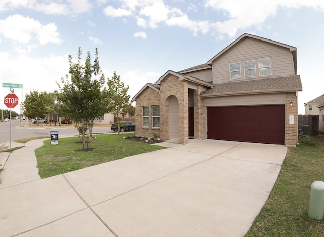 view of front of property with a garage and a front yard