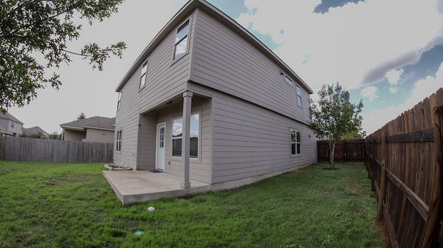 back of property with a patio and a yard