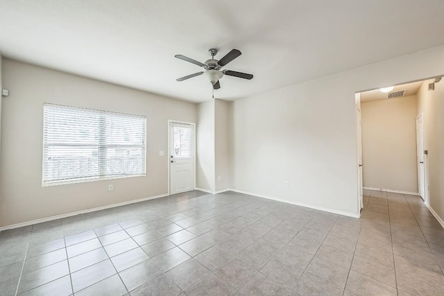 empty room featuring light tile patterned floors and ceiling fan