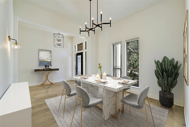 dining room featuring a notable chandelier and light hardwood / wood-style floors