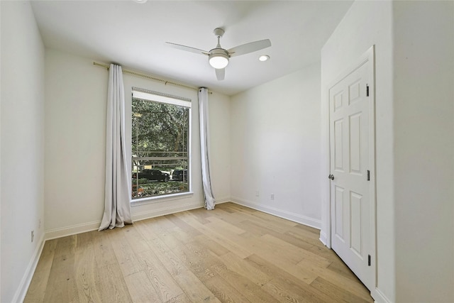 unfurnished room featuring ceiling fan, a healthy amount of sunlight, and light wood-type flooring