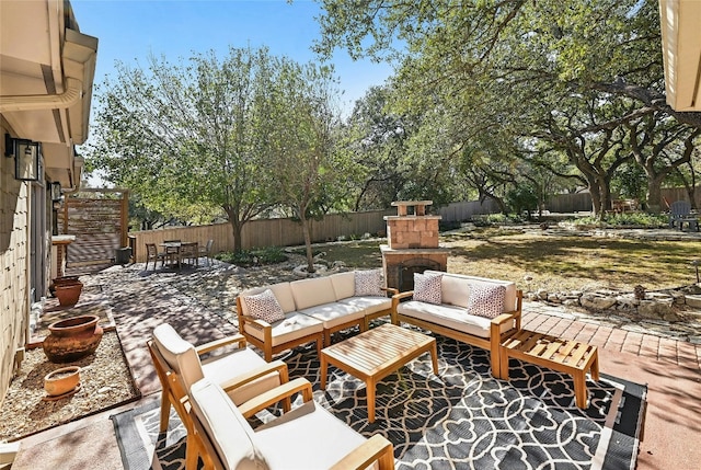 view of patio / terrace with an outdoor living space with a fireplace