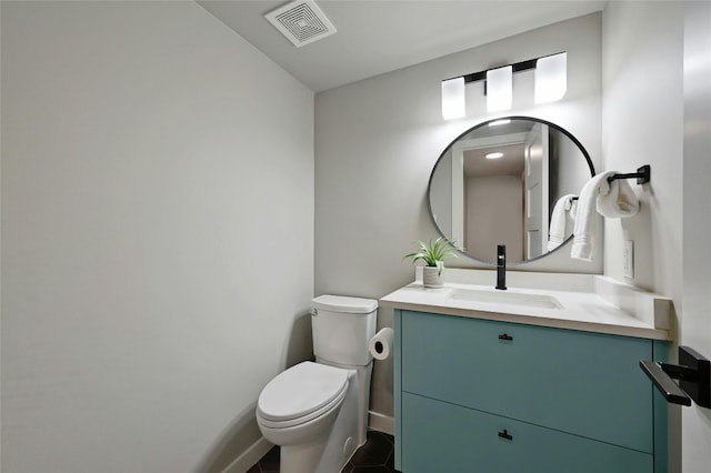 bathroom featuring tile patterned flooring, vanity, and toilet