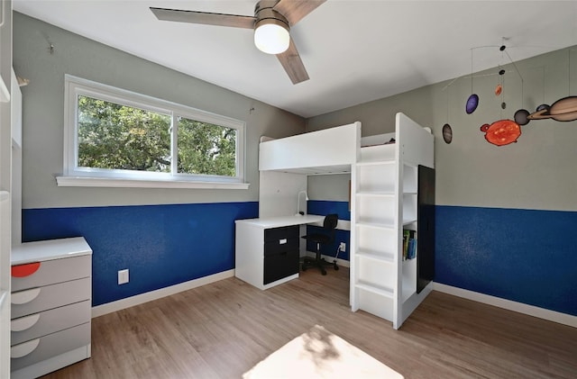 unfurnished bedroom with ceiling fan and light hardwood / wood-style flooring