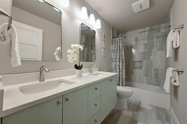 full bathroom with vanity, shower / bath combo, and toilet