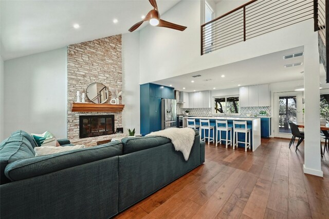 13016 S Madrone Trl, Austin, TX 78737 - living area featuring dark wood-style flooring, ceiling fan, high vaulted ceiling, and a fireplace