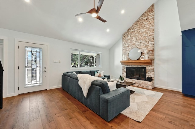 living room featuring ceiling fan, a fireplace, high vaulted ceiling, and hardwood / wood-style flooring