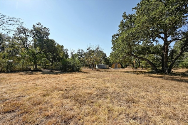 13016 S Madrone Trl, Austin, TX 78737 - view of green lawn with a shed