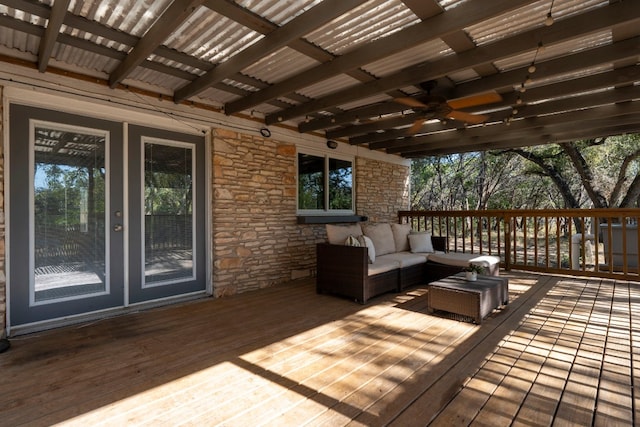 wooden deck with an outdoor living space and ceiling fan