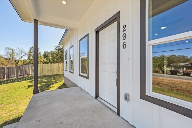 entrance to property with a lawn