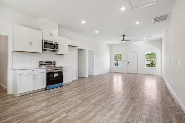 kitchen with white cabinetry, ceiling fan, stainless steel appliances, and light hardwood / wood-style floors