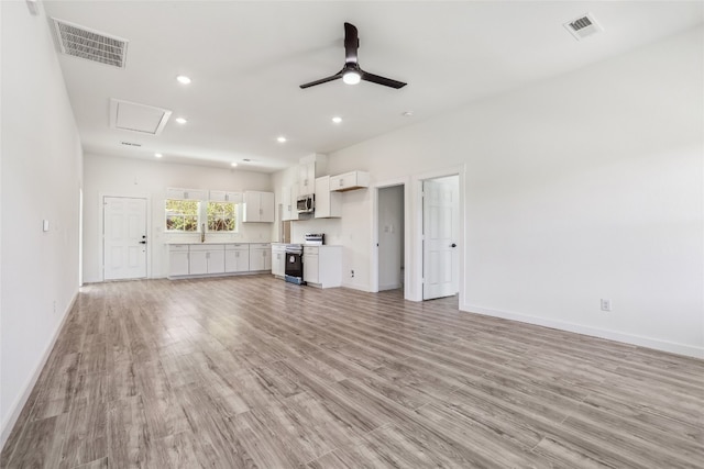 unfurnished living room featuring ceiling fan and light wood-type flooring