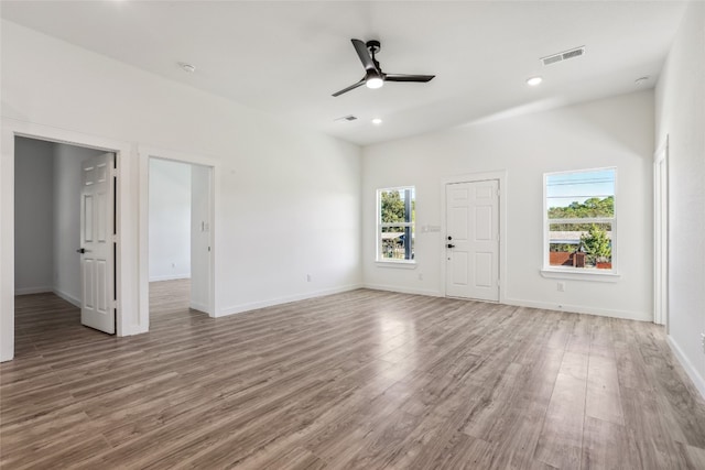 unfurnished living room featuring ceiling fan and wood-type flooring