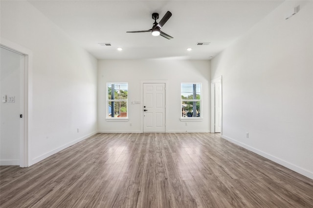 unfurnished living room with ceiling fan and wood-type flooring