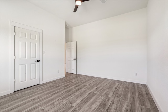 empty room featuring ceiling fan and light hardwood / wood-style floors