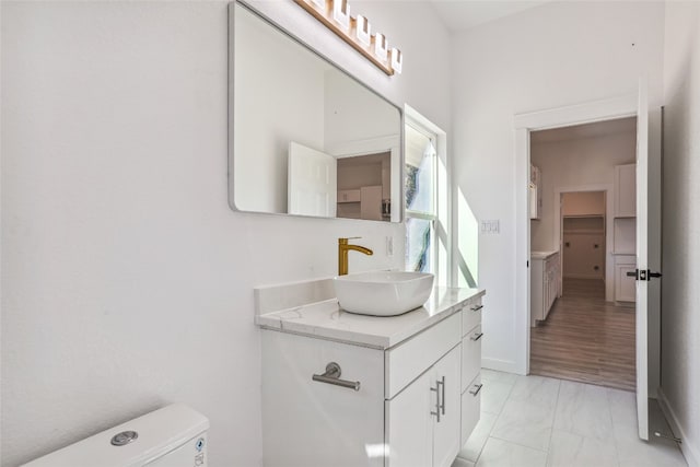 bathroom featuring vanity and toilet