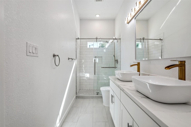 bathroom with vanity, toilet, and walk in shower