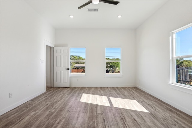 empty room with ceiling fan and light wood-type flooring