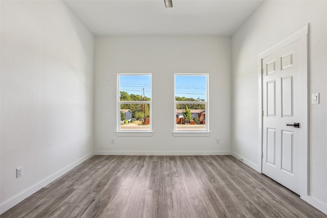 unfurnished room with hardwood / wood-style floors