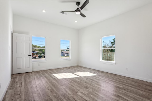 spare room featuring hardwood / wood-style floors and ceiling fan